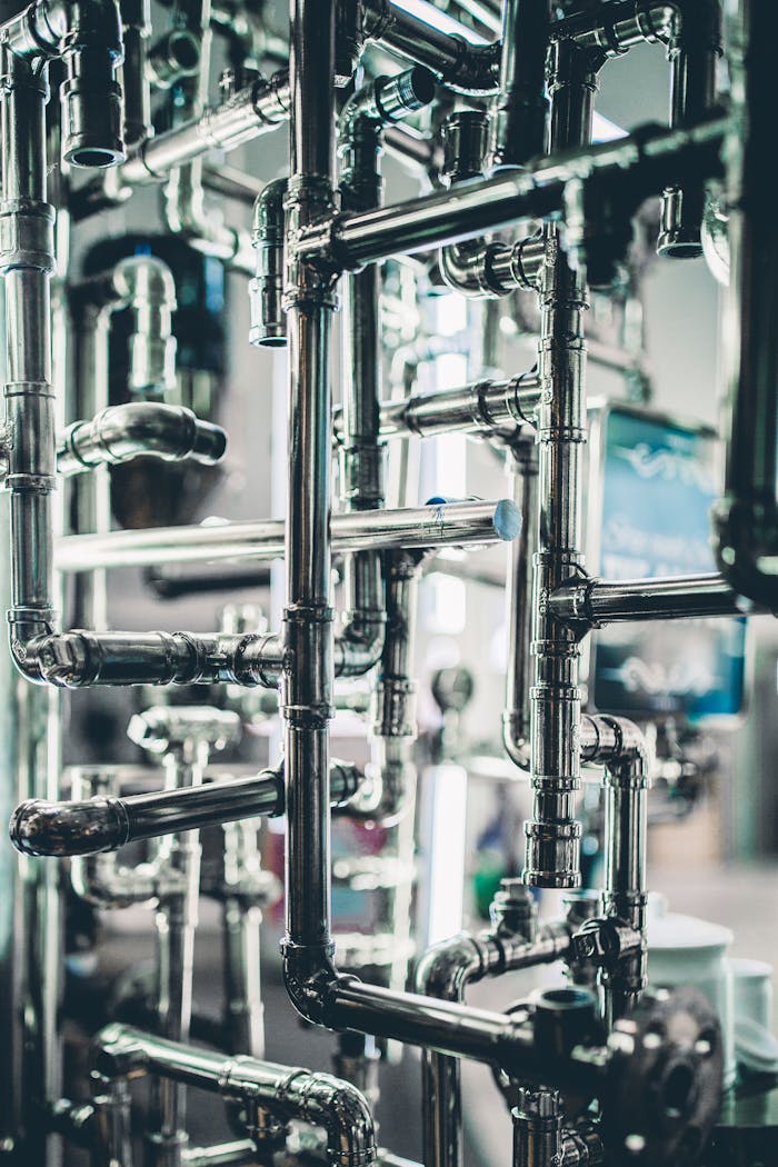 Home Close-up of complex stainless steel pipes in an industrial setting, showcasing modern engineering.